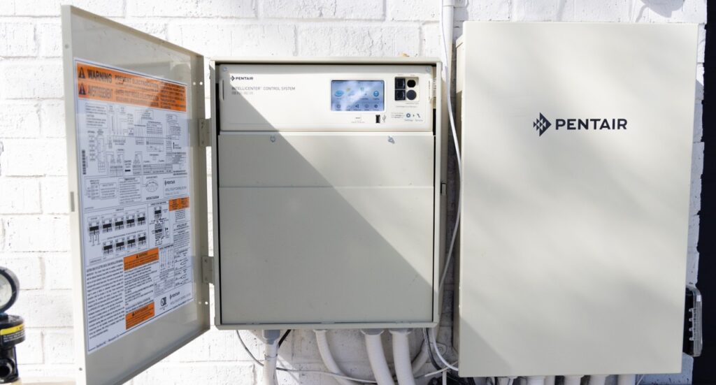 Pentair automation panel opened for service by a Bright Water technician