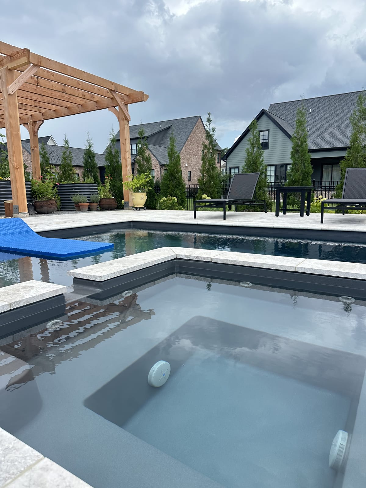 Spa and pool beside a pergola, serviced by Bright Water